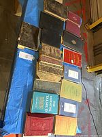Overview of books spread on table showing variety of bindings and languages