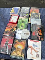 Entire lot laid out showing DVDs, dictionaries and loose disc