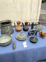 Full group of metalware on blanket