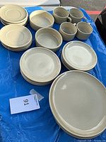 Overhead view of entire dinnerware set showing plates, bowls and mugs