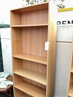 Front view of tall beech laminate bookcase showing five shelf surfaces