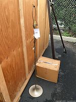 Full view of lamp beside crate showing entire structure and base