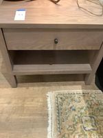 Front view of nightstand showing drawer, knob and lower shelf