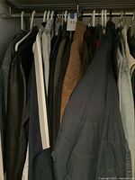 Closet view of multiple jackets on hangers