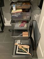 Tower of mesh drawers showing assorted envelopes, folders and paper supplies