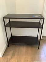 full view of black metal three-tier shelf