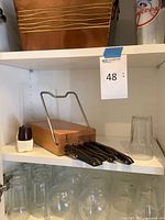 Knife block, knives, sharpener, glassware on shelves