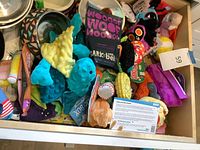 Drawer view showing bulk of plush toys and two nested bowls
