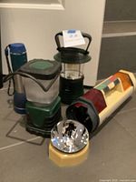 Group shot of five flashlights and lanterns