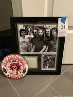 Lot overview showing framed collage and ceramic plaque