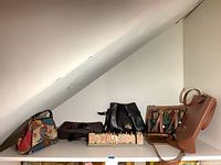 All six purses and menorah on shelf