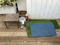 Group shot of metal stool, trash can, blue mat, artificial grass mats, red fire hydrant