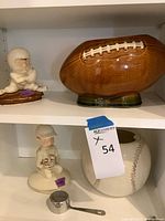Both cookie jars on shelf, football jar upper right, baseball jar lower right, lids shown separately