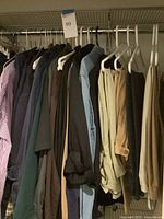 Shirts and pants hanging on closet rod
