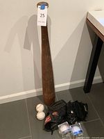 Full lot with wooden bat, two gloves, two loose baseballs, two cased baseballs