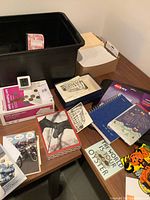 Overview of office supplies, stationery and foreign currency on table