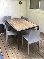 Outdoor dining table and chairs on deck