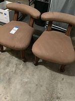 Pair of low brown upholstered chairs front view