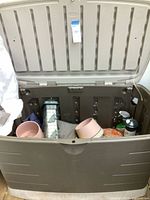 Overall view of Rubbermaid storage box open showing contents