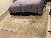 Full view of rug under bed showing overall design and size