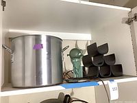 Stock pot, wine rack, lamp on shelf