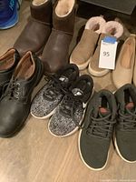 Group of shoes showing black leather dress shoes, Nike sneakers, brown boots, tan slip-ons, beige flats