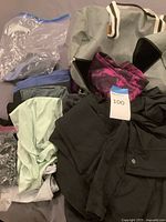 Group shot of all athletic wear and tote bag laid out