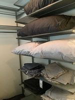 Shelving with pillows and folded linens