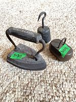 Top view of sad iron, cylindrical hook weight, oval weight