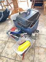 Group shot of barbecue on coolers with utensils and other items