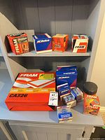 All boxed filters, thermostat, spark plugs and canister on shelves