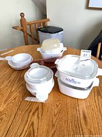 Group of CorningWare dishes and Pyrex baking dish on table