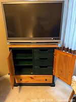 Front view showing dresser with cabinet doors open revealing four drawers, bottom full-width drawer pulled slightly