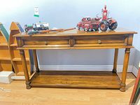 Full view of wood console table with two drawers and lower shelf