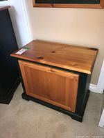 Front angled view of wood chest showing recessed panel and two-tone finish