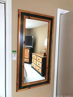 Front view of rectangular wall mirror hanging on wall