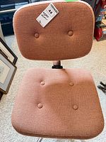 Front view of chair showing upholstery and tufted buttons