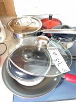 Stacked cookware showing lids and handles