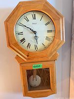 Front view of Kieninger wall clock showing dial, pendulum window and overall condition