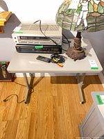 Front view showing tabletop, legs and items placed on top