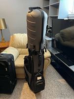 Front view of grey/black TourTrek wheeled travel golf case standing upright