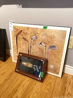 Both wall art pieces leaning against wall