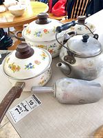 Group shot of three enamel pots, aluminum kettle, aluminum scoop