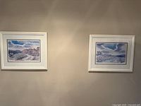 Both framed lithograph prints side by side on wall