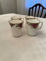 Four Royal Albert Old Country Roses cups on table