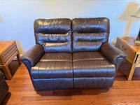 Front view of brown leather power reclining loveseat