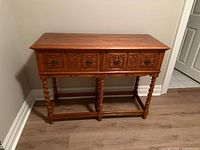 Front view of carved wood console table