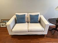 Front view of IKEA beige slipcovered loveseat