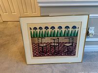 Full view of framed etching leaning against wall