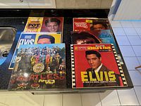 Six vinyl LPs laid out on countertop displaying covers